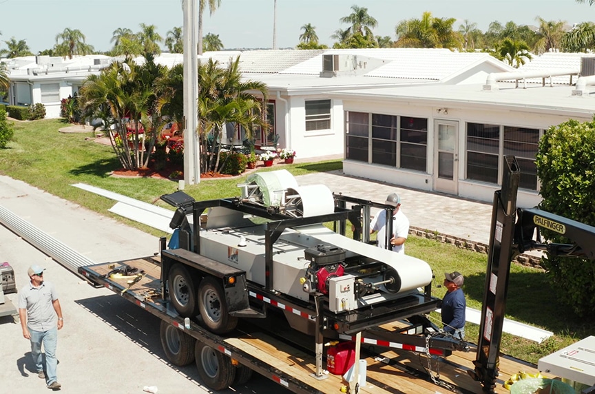 portable roof panel machine on trailer at residential job site