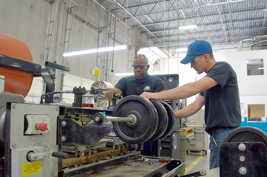 service technicians working with portable rollformer