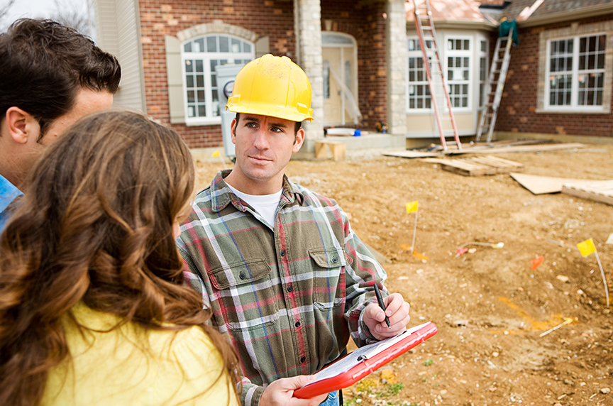 a contractor talking to people in front of home