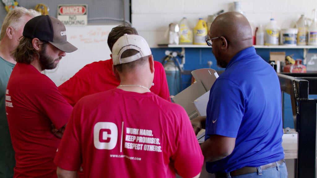 Service technician training group of people on portable rollforming machine