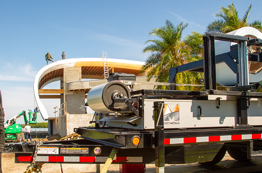 portable roof panel machine in front of residential radius roof