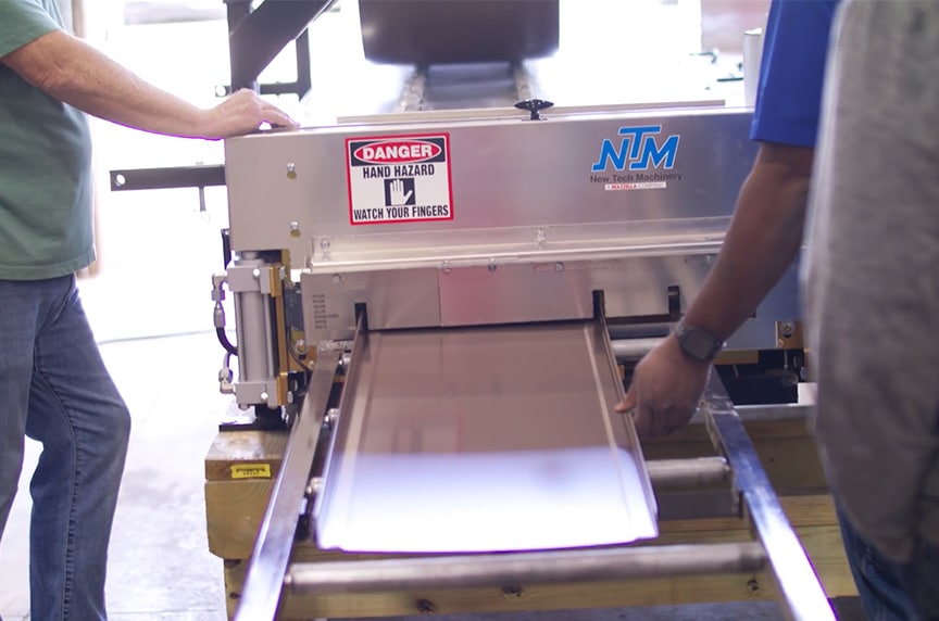 roof panel coming out of portable rollforming machine onto run out stand