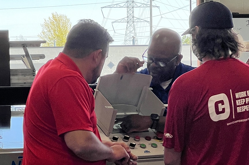 Service Technician pointing to UNIQ Controller screen