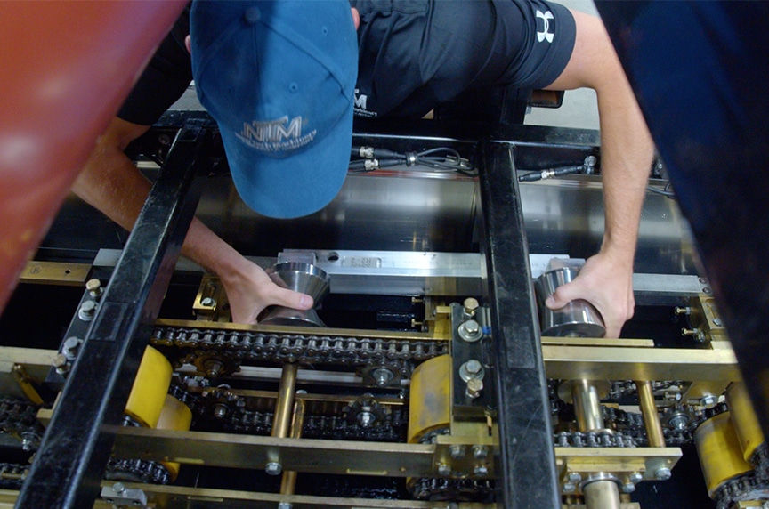 NTM Service Technician changing tooling set inside SSQ II MultiPro Roof Panel Machine