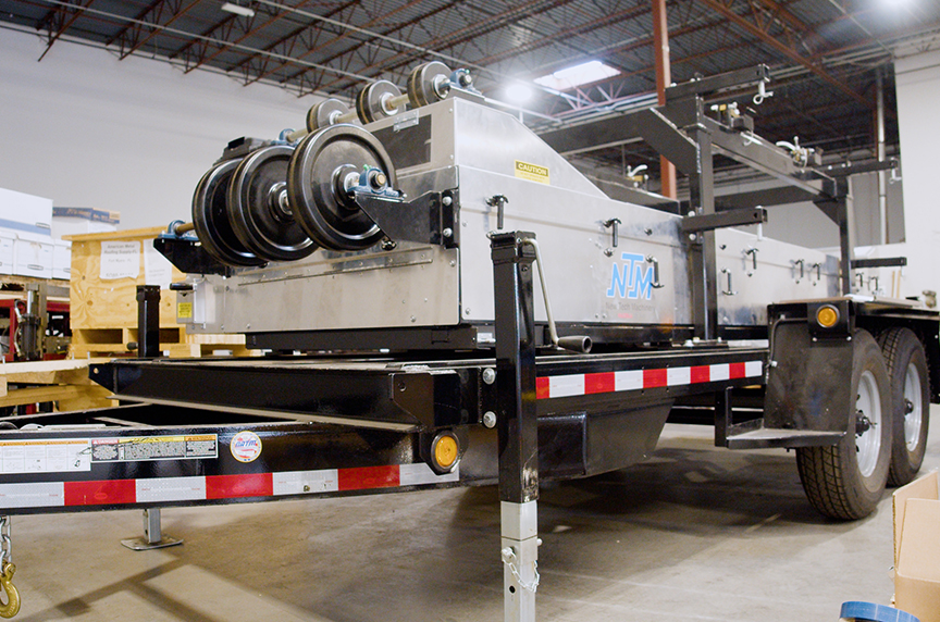 An SSQ II machine sits on a trailer inside a shop