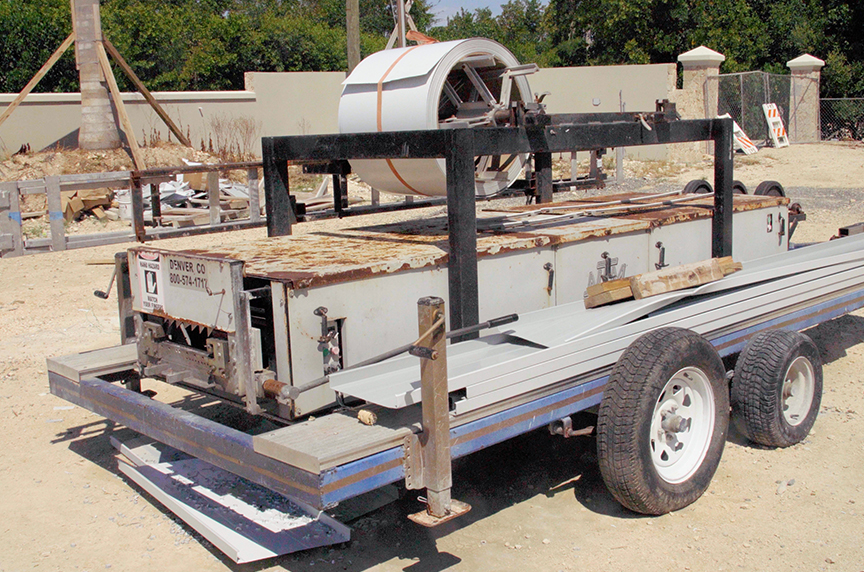 An NTM SSR machine sits outside on a trailer covered in rust