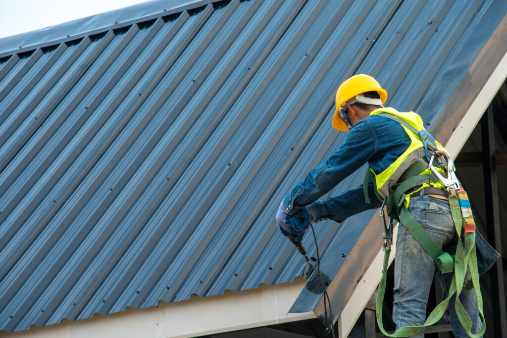 Installing an exposed fastener metal roof.