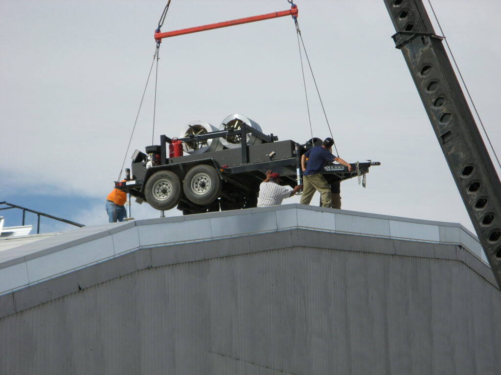 SSQ machine lifted onto rooftop.
