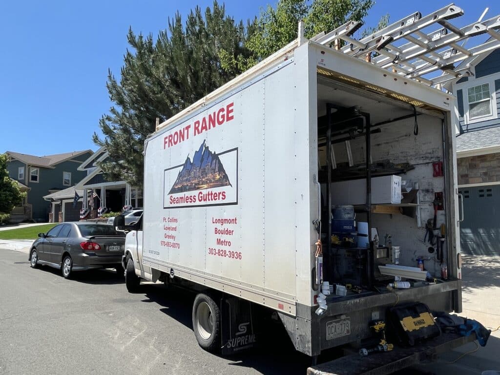 Gutter service truck for Front Range Seamless Gutters with rear open and gutter machine in back.