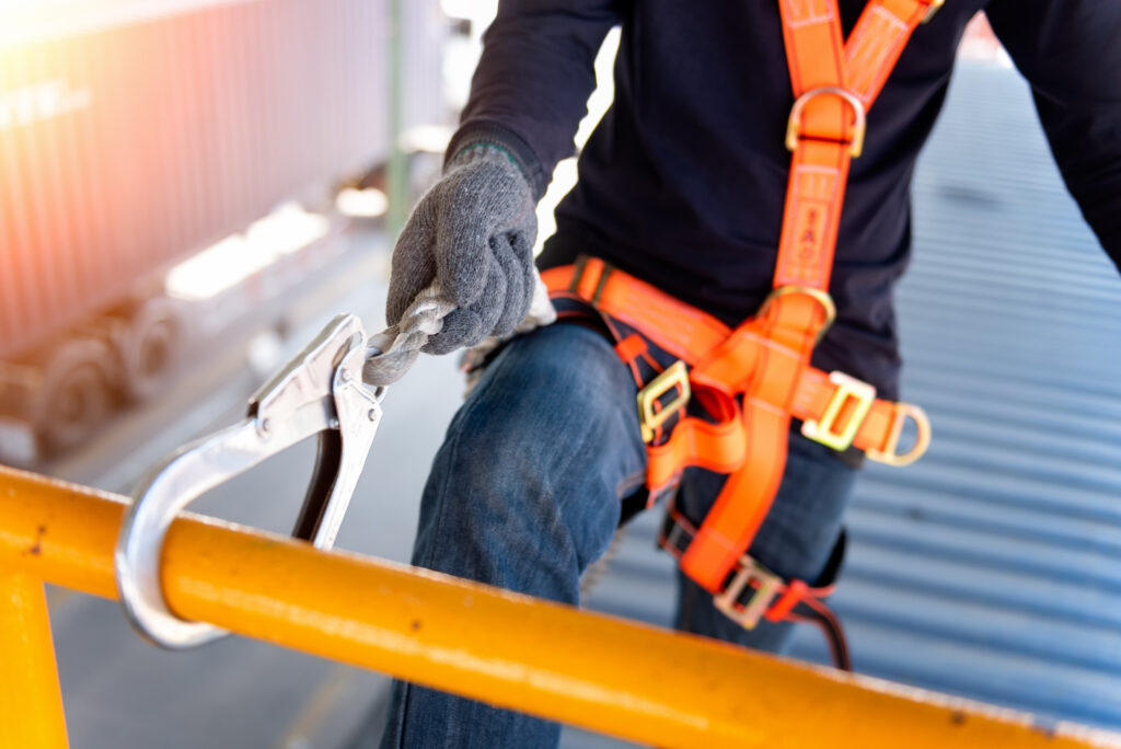 Worker with safety harness.