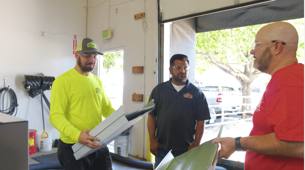 Tim training two operators.