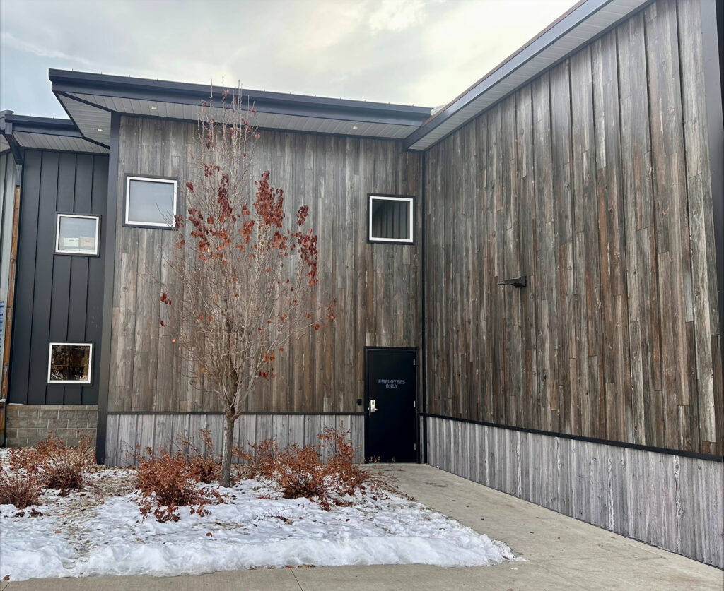 board and batten siding with weathered metal.
