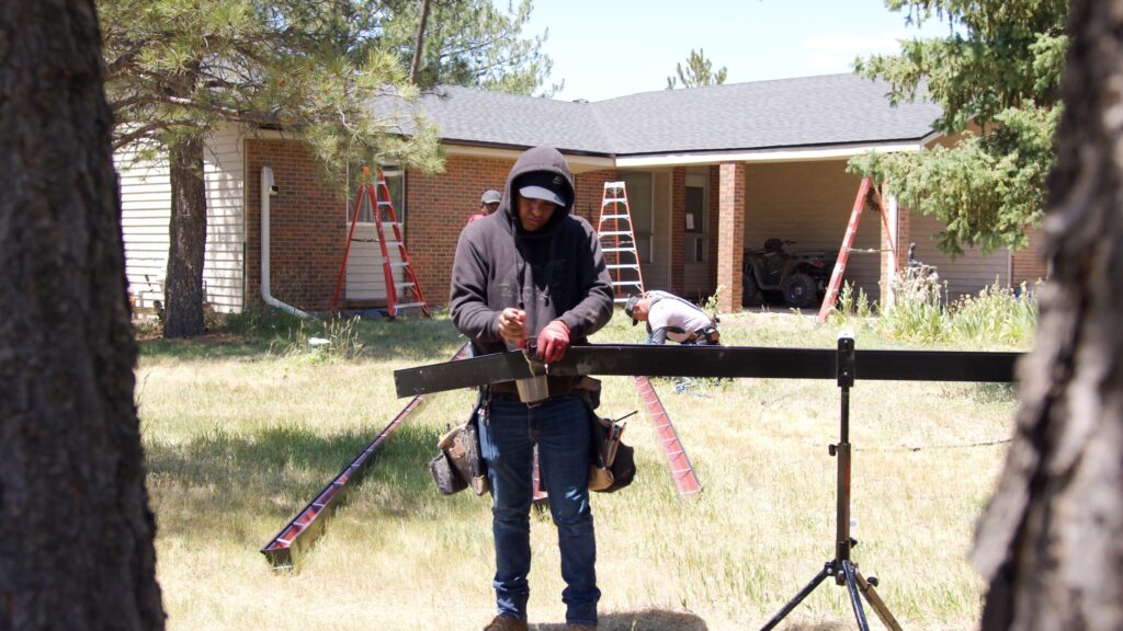 NTM MACH II seamless gutter machine on a jobsite