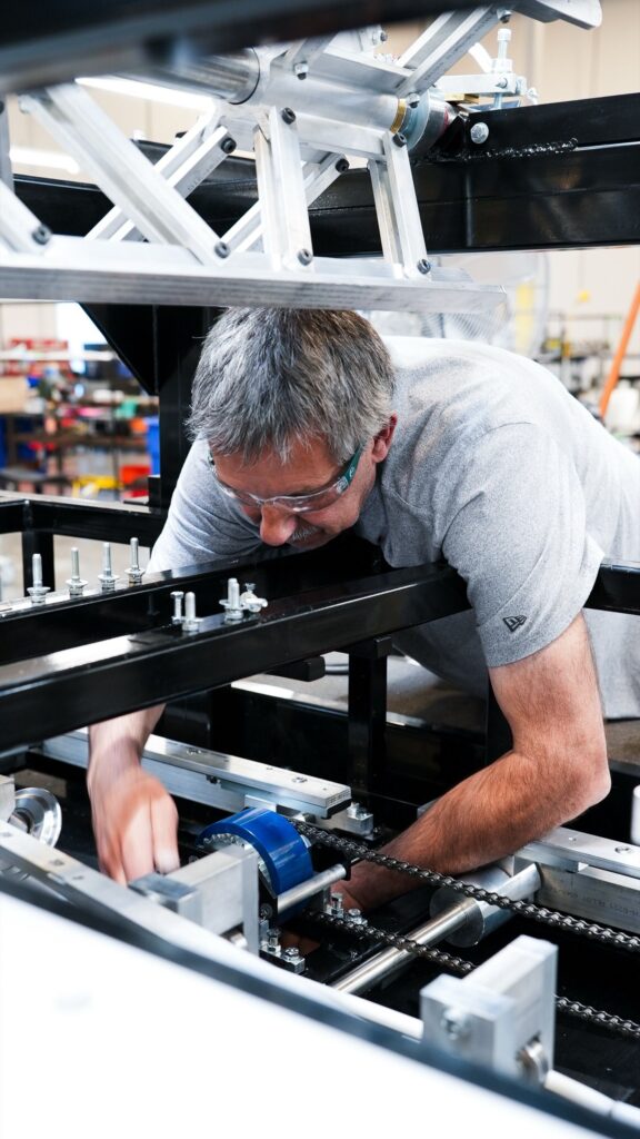 NTM service technician working on a rollforming machine at the Aurora Service & Engineering Center.